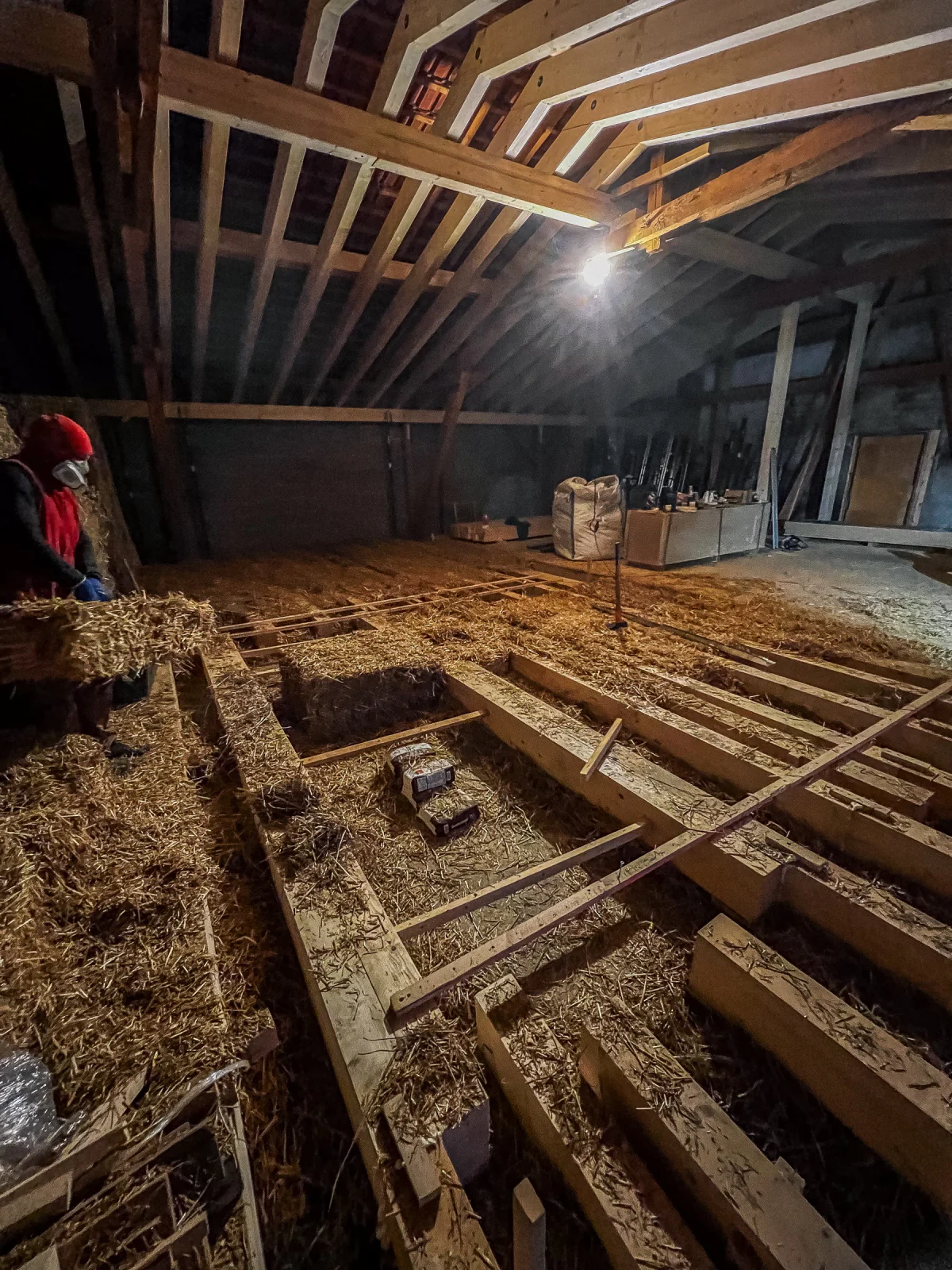 Straw packed between load bearing timber trusses